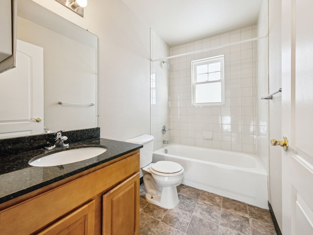 bathroom with toilet, vanity, and shower / bathtub combination