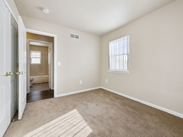 unfurnished bedroom featuring carpet floors, a closet, visible vents, and baseboards