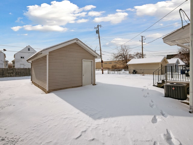 exterior space featuring cooling unit, fence, and an outdoor structure