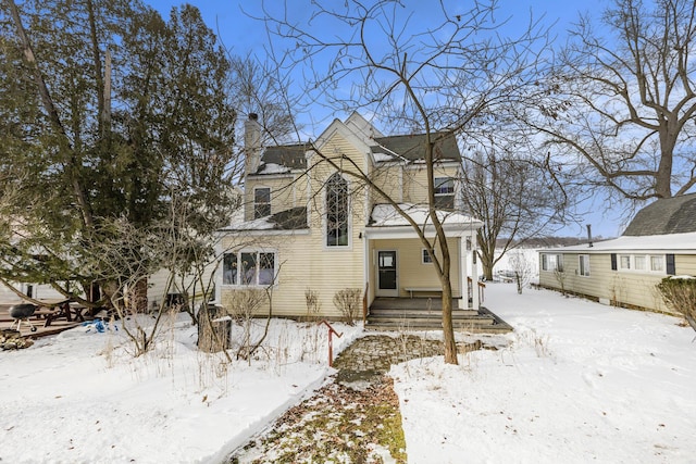 view of front of home featuring a chimney