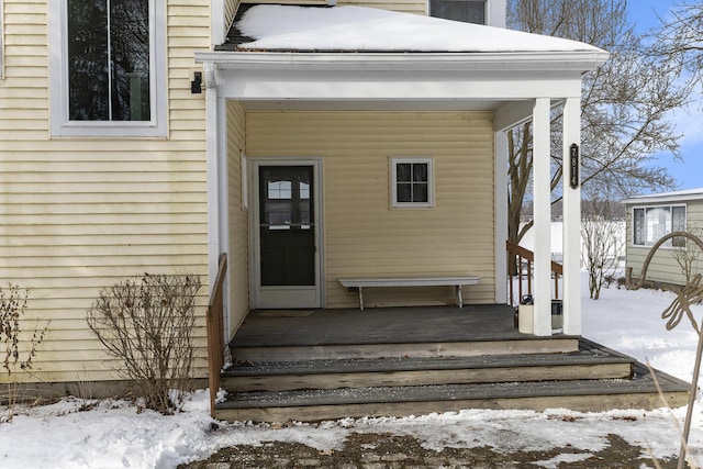 view of snow covered property entrance