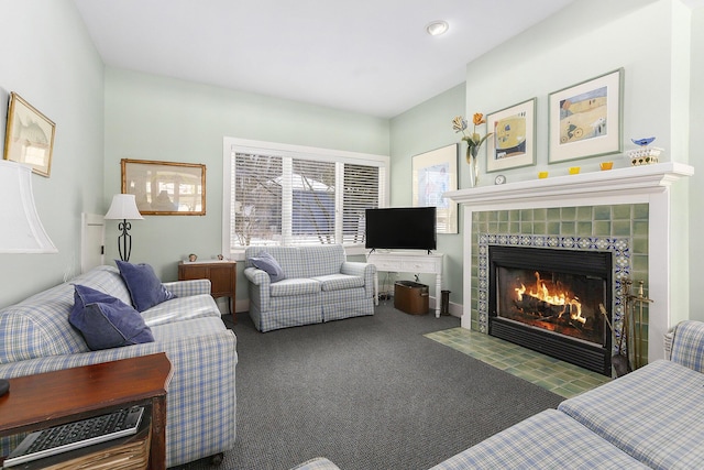 living room featuring dark colored carpet and a tiled fireplace