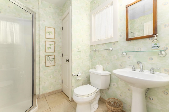 bathroom featuring baseboards, tile patterned flooring, toilet, and wallpapered walls