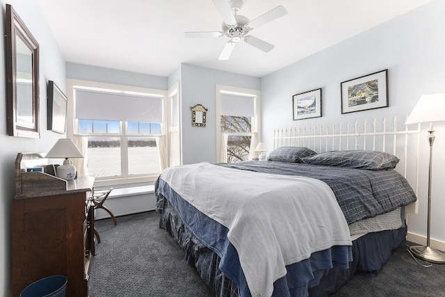 bedroom with a ceiling fan, dark carpet, and baseboards