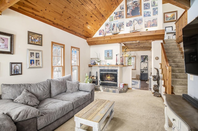 living room with a glass covered fireplace, wood ceiling, carpet flooring, high vaulted ceiling, and stairs