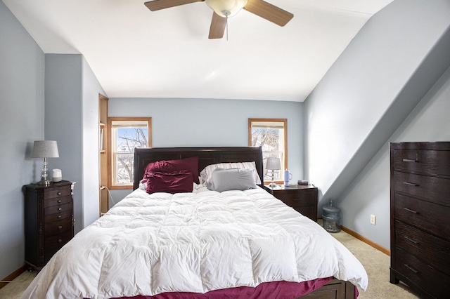 bedroom with multiple windows, baseboards, a ceiling fan, and light colored carpet