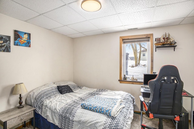 bedroom featuring carpet floors, a paneled ceiling, visible vents, and baseboards