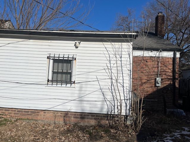 view of side of property with a chimney