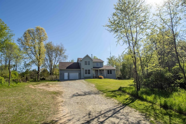 4898 Mount Morris Rd, Columbiaville, MI 48421 - view of front of home featuring a garage, dirt driveway, and a front yard