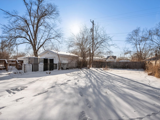 snowy yard featuring fence