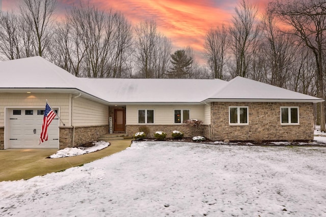 single story home with a garage, stone siding, and driveway