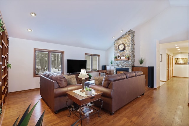 living area with a healthy amount of sunlight, light wood-style flooring, and a fireplace