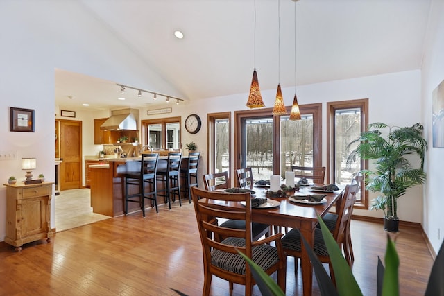 dining room featuring light wood-style floors, baseboards, high vaulted ceiling, and recessed lighting