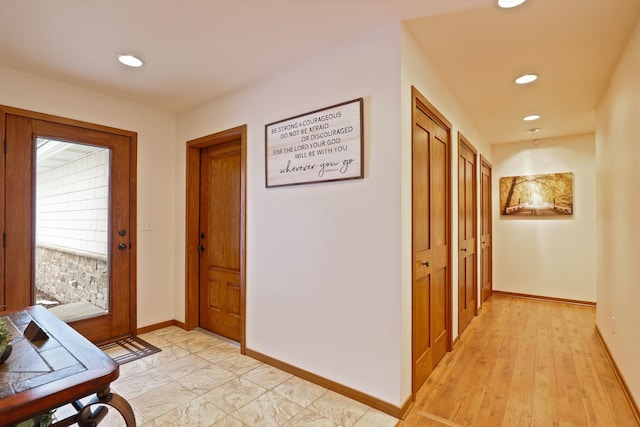 hallway featuring baseboards and recessed lighting