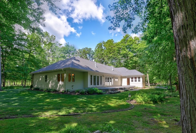 rear view of property with a lawn