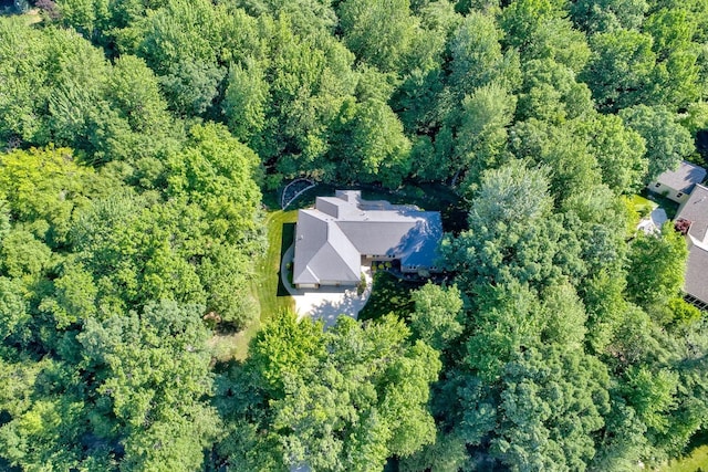 birds eye view of property featuring a view of trees