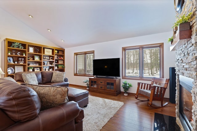 living room with dark wood-style floors, a fireplace, vaulted ceiling, and recessed lighting