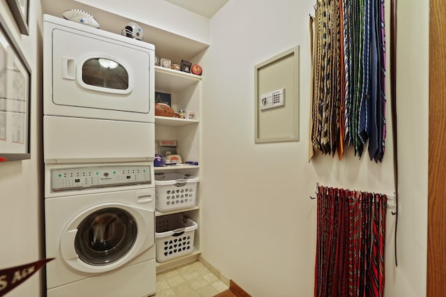 laundry area featuring laundry area, baseboards, and stacked washer and dryer