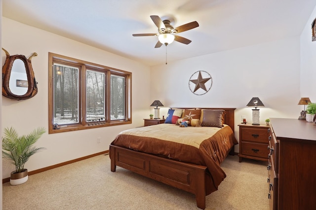 bedroom with light carpet, ceiling fan, and baseboards