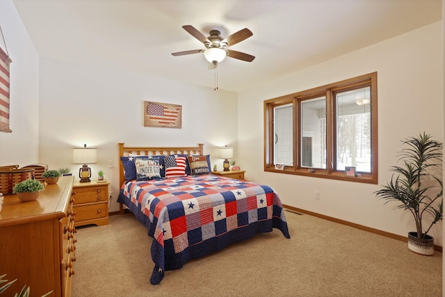 bedroom with a ceiling fan, light colored carpet, and baseboards