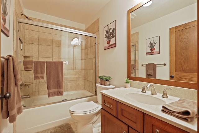 full bathroom featuring toilet, enclosed tub / shower combo, and vanity