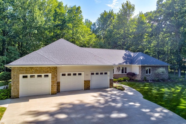 ranch-style home featuring concrete driveway, an attached garage, and a front lawn