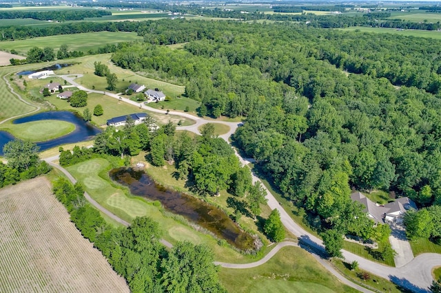 birds eye view of property featuring a view of trees