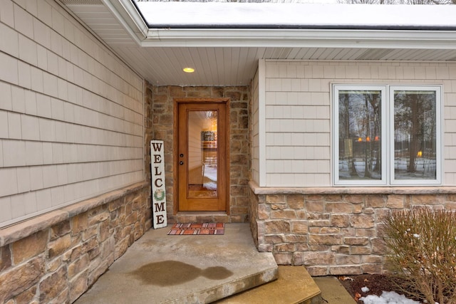 property entrance with stone siding