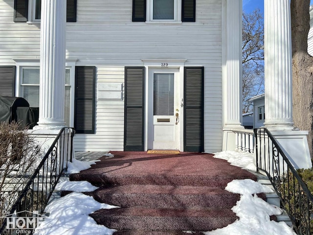 view of snow covered property entrance