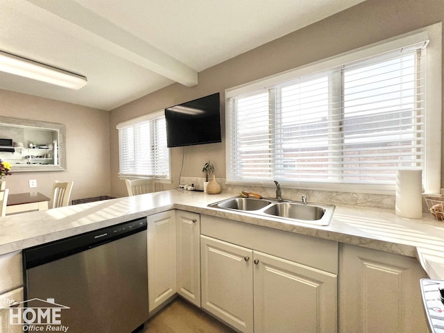 kitchen featuring light countertops, dishwasher, beamed ceiling, and a sink