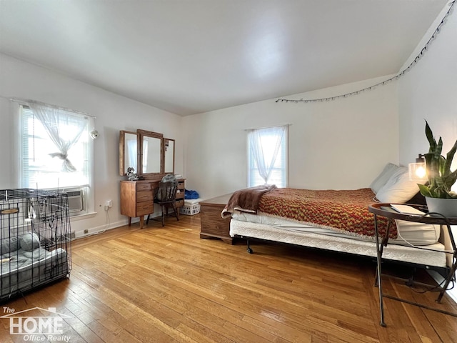 bedroom featuring light wood-style floors and baseboards