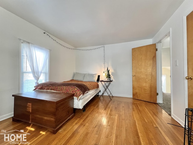 bedroom featuring baseboards and wood finished floors