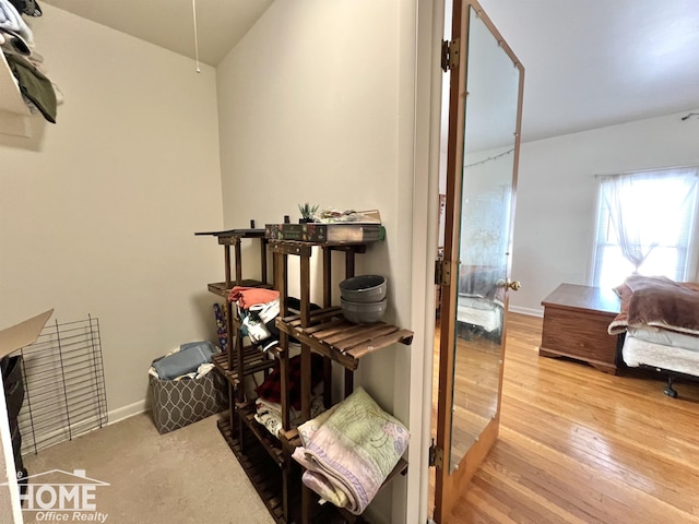 interior space featuring baseboards and wood finished floors