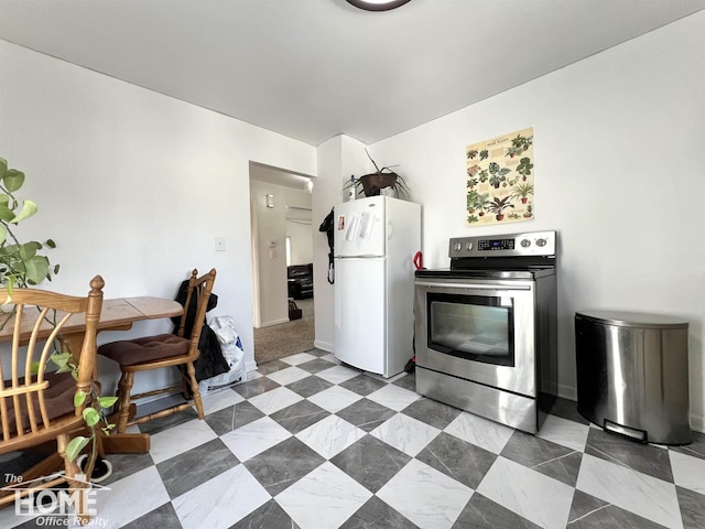 kitchen with freestanding refrigerator and stainless steel electric range oven