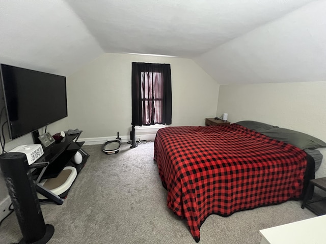 bedroom featuring vaulted ceiling, baseboards, and light colored carpet