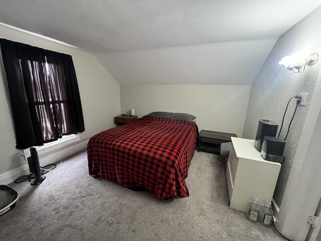 bedroom featuring lofted ceiling, light carpet, and a textured wall