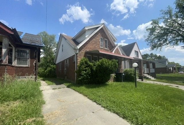 view of property exterior featuring a yard and brick siding