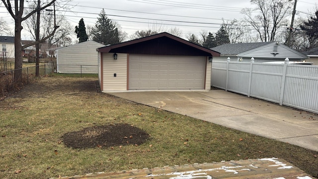 detached garage featuring fence