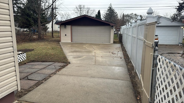 detached garage featuring fence