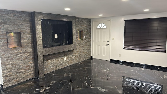 entryway featuring baseboards, marble finish floor, and recessed lighting