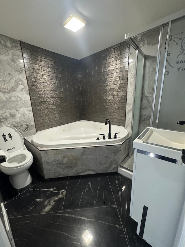 bathroom featuring toilet, marble finish floor, vanity, and a bath