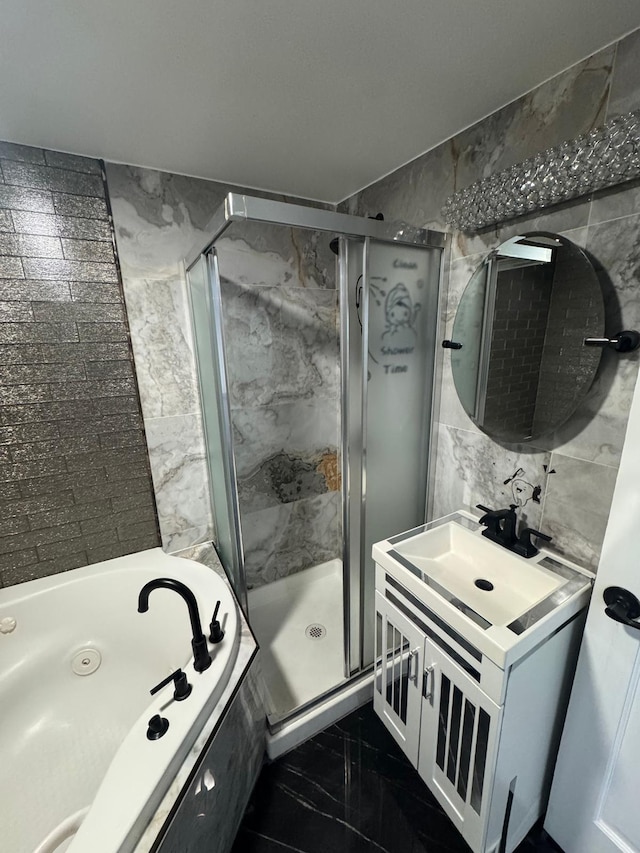 bathroom featuring marble finish floor, a tub with jets, a shower stall, and tile walls