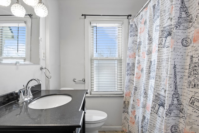 full bathroom with toilet and vanity