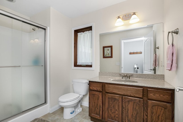 bathroom featuring tile patterned flooring, toilet, vanity, baseboards, and a shower stall