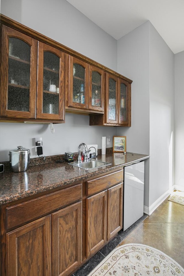 bar with baseboards, a sink, finished concrete flooring, and stainless steel dishwasher