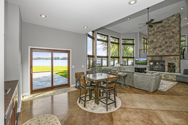 dining room featuring a wealth of natural light, light tile patterned floors, a fireplace, and recessed lighting