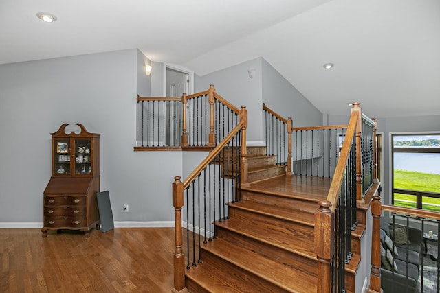 stairs featuring lofted ceiling, recessed lighting, wood finished floors, and baseboards