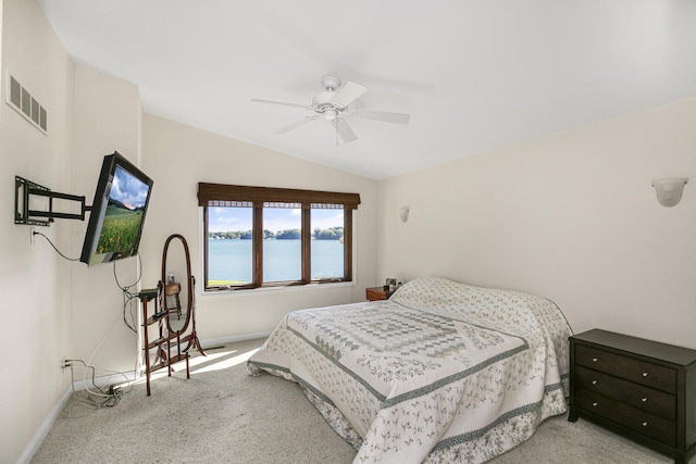 bedroom featuring vaulted ceiling, baseboards, visible vents, and light colored carpet