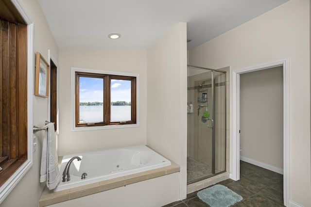 bathroom featuring a whirlpool tub, a water view, a shower stall, and baseboards