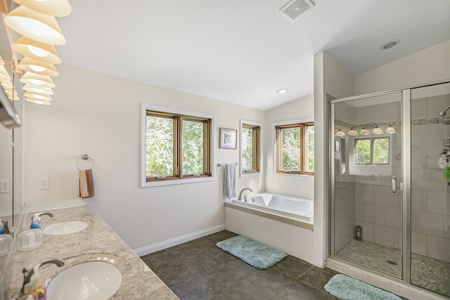 bathroom with vaulted ceiling, a wealth of natural light, a sink, and visible vents